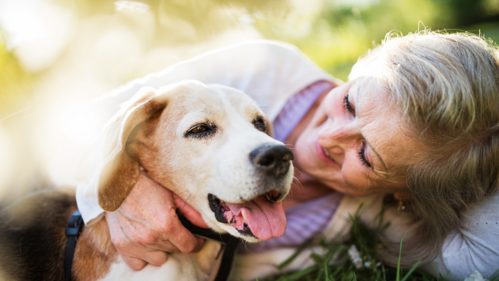 older lady hugging a dog