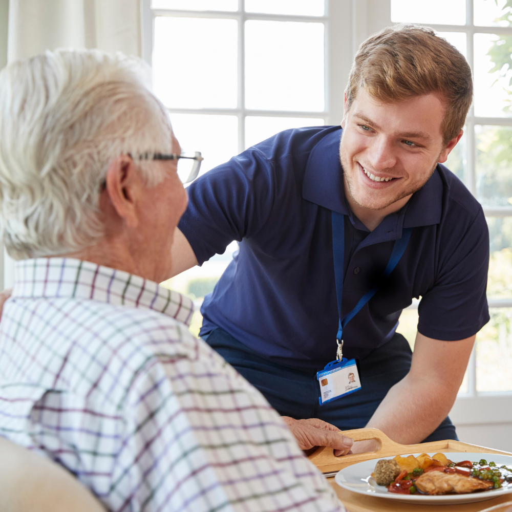 young male nurse interacting with elderly patient