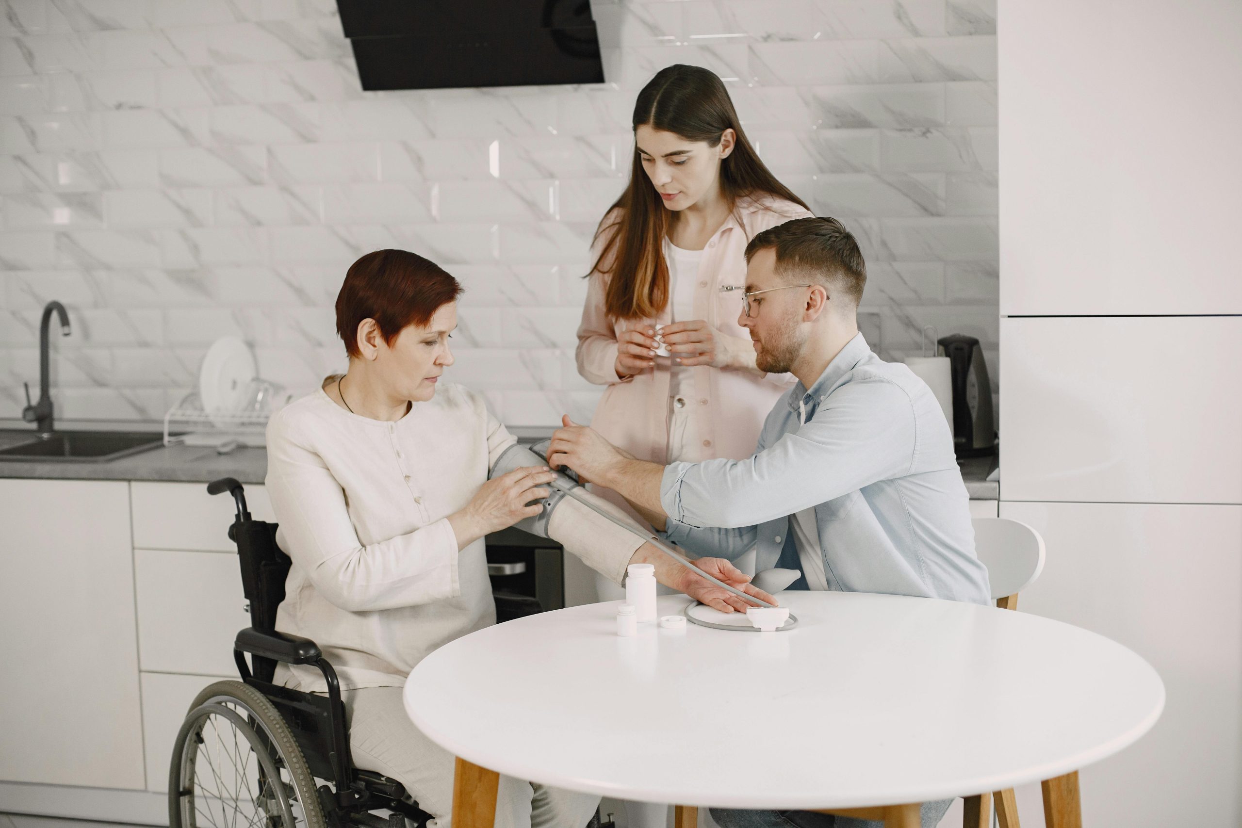 A family monitors blood pressure at home, ensuring health and wellness. Home Care and Hospice